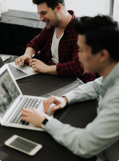 Two people coding and talking