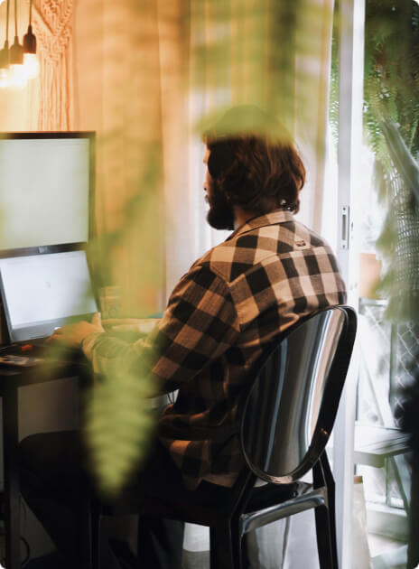 Person from the back, sitting on a chair and coding